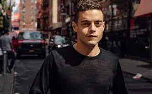Rami Malek Pose On Busy Street Wallpaper