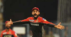 Rcb Team Kohli Arms Outstretched Wallpaper