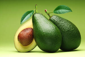 Real Avocado Fruit With A Leaf Portrait Image Wallpaper