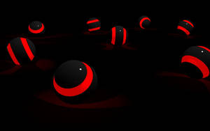 Red And Black Spheres In A Captivating 3d Pattern Wallpaper