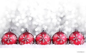 Red Christmas Balls With Snowflakes Laying On Snow Wallpaper