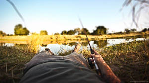 Reeling It In - A Fisherman Enjoying His Catch Wallpaper