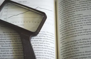Reference Book With Magnifying Glass Wallpaper