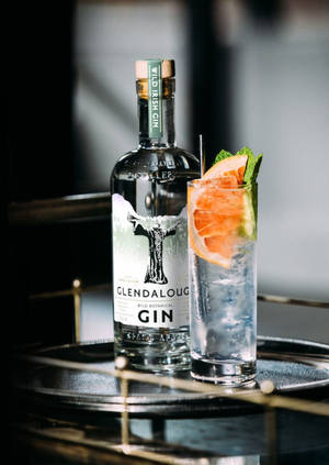 Refreshing Glendalough Wild Gin Tonic Cocktail Against A Rustic Backdrop Wallpaper