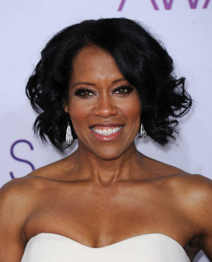 Regina King Smiling In White Dress Portrait Wallpaper