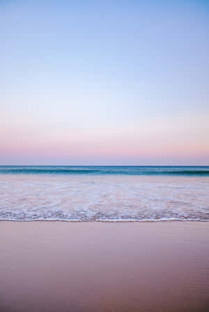 Relax On The Tranquil Pastel Coloured Beach, Perfect For Summer Days. Wallpaper