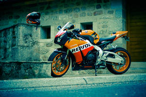 Repsol Honda Motorbike And Helmet Wallpaper