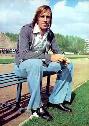 Retro Footballer Sittingon Bench Wallpaper