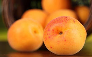 Ripe Apricot Fruits On Red Dotted Background Wallpaper