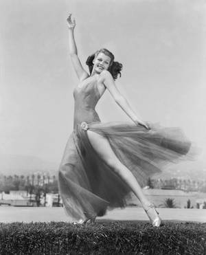 Rita Hayworth Dancing On Grass Wallpaper