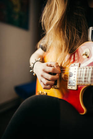 Rockin' Out With Her Electric Guitar Wallpaper