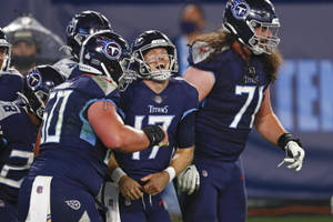 Ryan Tannehill Laughing With Tennessee Titans Teammates Wallpaper