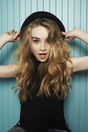 Sabrina Carpenter Playful Hat Pose Wallpaper