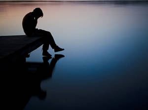 Sad Aesthetic Man Sitting At Dock Wallpaper