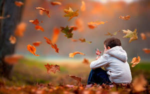Sad Boy With Autumn Leaves Wallpaper