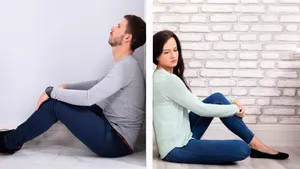 Sad Couple Sitting On Floor Wallpaper