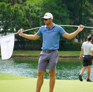 Sam Burns Carrying White Golf Flag Wallpaper