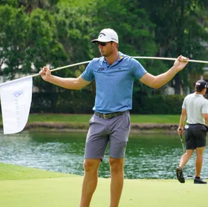 Sam Burns Carrying White Golf Flag Wallpaper