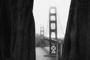 San Francisco's Iconic Fog Rolling Over The Golden Gate Bridge Wallpaper