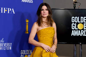 Sandra Bullock In Golden Gown Wallpaper
