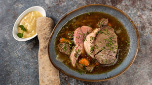 Savoring Traditional German Sauerbraten Meal Wallpaper