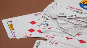 Scattered Deck Of Rummy Playing Cards Wallpaper