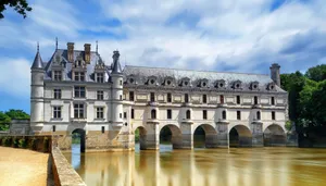 Scenic View Of Château De Chenonceau Over The Muddy River Wallpaper