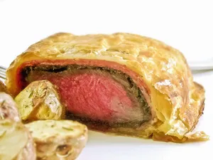 Scrumptious Beef Wellington With A Side Of Garlic Bread Wallpaper