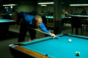 Seasoned Professional Showcasing His Skills In Billiards Wallpaper