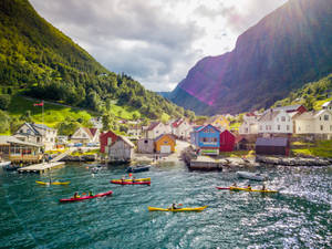 Serene Kayaking Adventure In Friendly Town Wallpaper