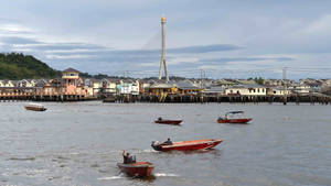 Serene View Of Boats On The Brunei River Wallpaper