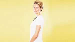 Shailene Woodley In Yellow Background Wallpaper