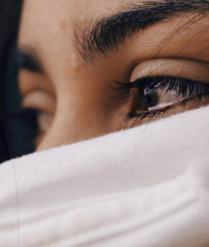 Shallow Focus Of A Woman's Sad Eyes Wallpaper