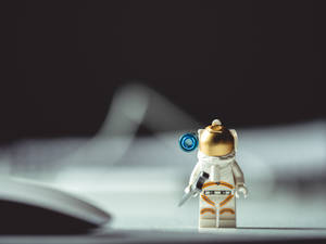 Shallow Focus Photo Of Astronaut Mini Figur E Wallpaper