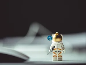 Shallow Focus Photo Of Astronaut Mini Figur E Wallpaper