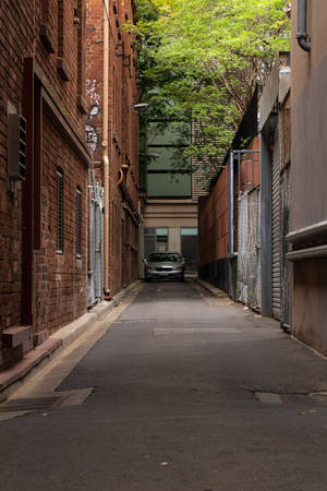 Shallow Focus Photo Of Gray Car Parked On Alley Wallpaper