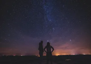 Silhouette Of People Under Milky Way Wallpaper