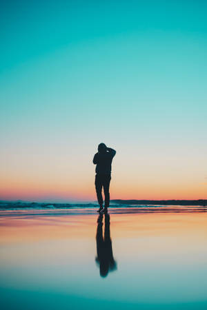Silhouette Of Person In Seashore During Daytime Wallpaper