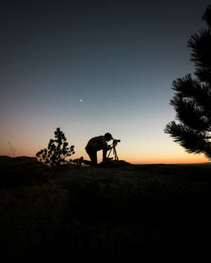 Silhouette Photography Of Man Capturing Photo During Night Time Wallpaper