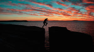 Silhouette Tenacious Mountain Climber Wallpaper