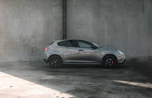 Silver Suv Parked Near Wall Wallpaper