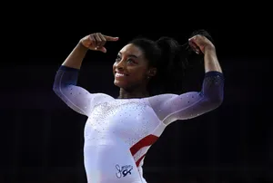 Simon Biles Performing Happily Wallpaper