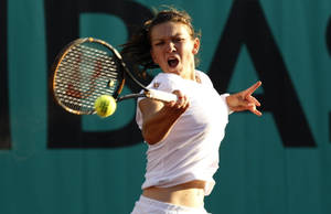 Simona Halep In Action During A Tennis Match Wallpaper