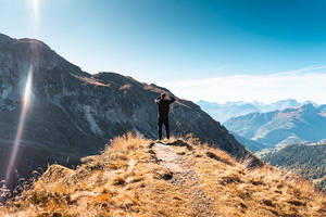 Single Boy Standing On A Mountain Wallpaper