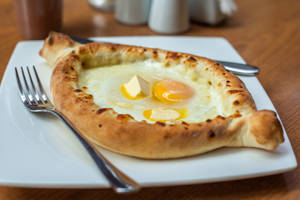 Sizzling Khachapuri Loaded With Melted Cheese And Egg Wallpaper