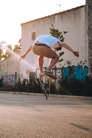 Skateboarder Performing A Stubborn Flip Wallpaper