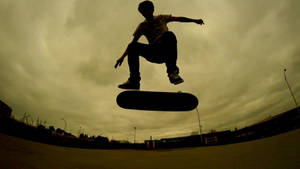 Skateboarder Takes A Big Jump Wallpaper