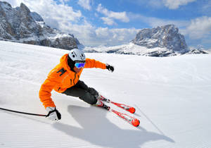 Skier Mastering The Alpine Slopes Wallpaper