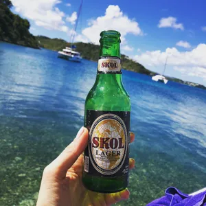 Skol Lager Bottle Tropical Backdrop Wallpaper