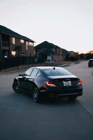Sleek Black Sedan At Dusk Wallpaper